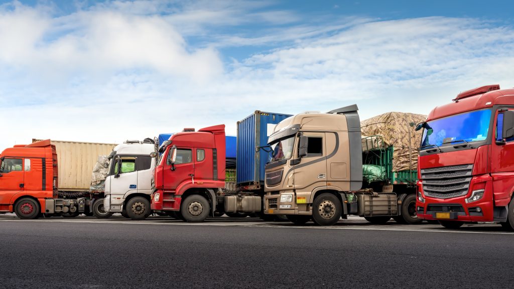 Tractor-trailers with freight containers parked side by side